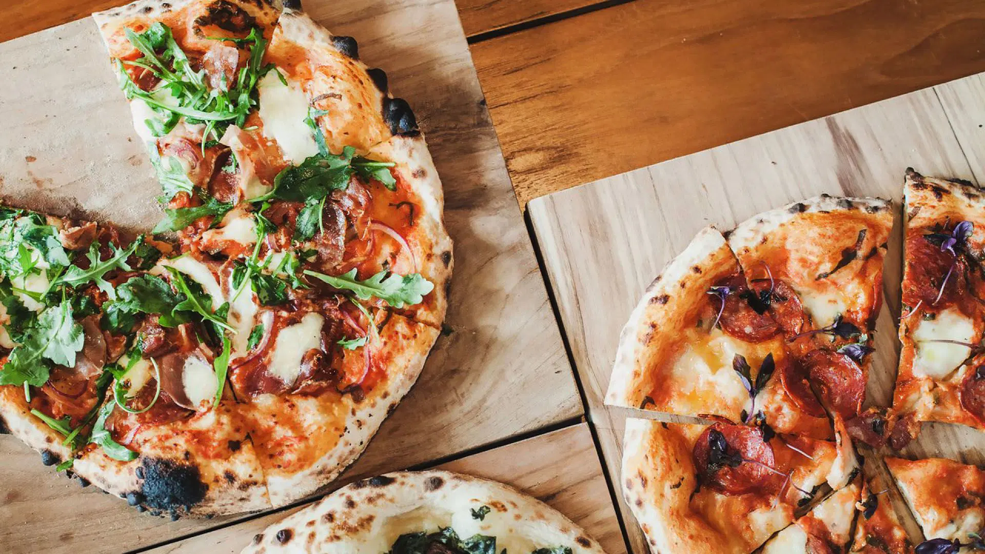 Open-air dining with a serene oceanside setting and sunset views from the Beacfront Restauran at Potato Head Bali.