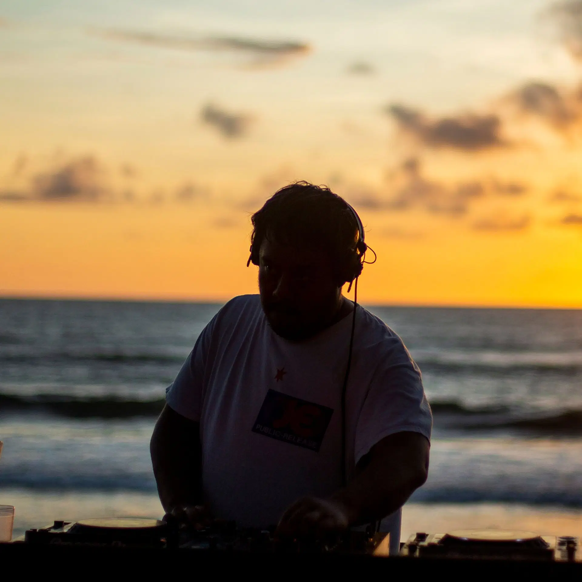 DJ silhouette at sunset on the beach, Potato Head Beach Club