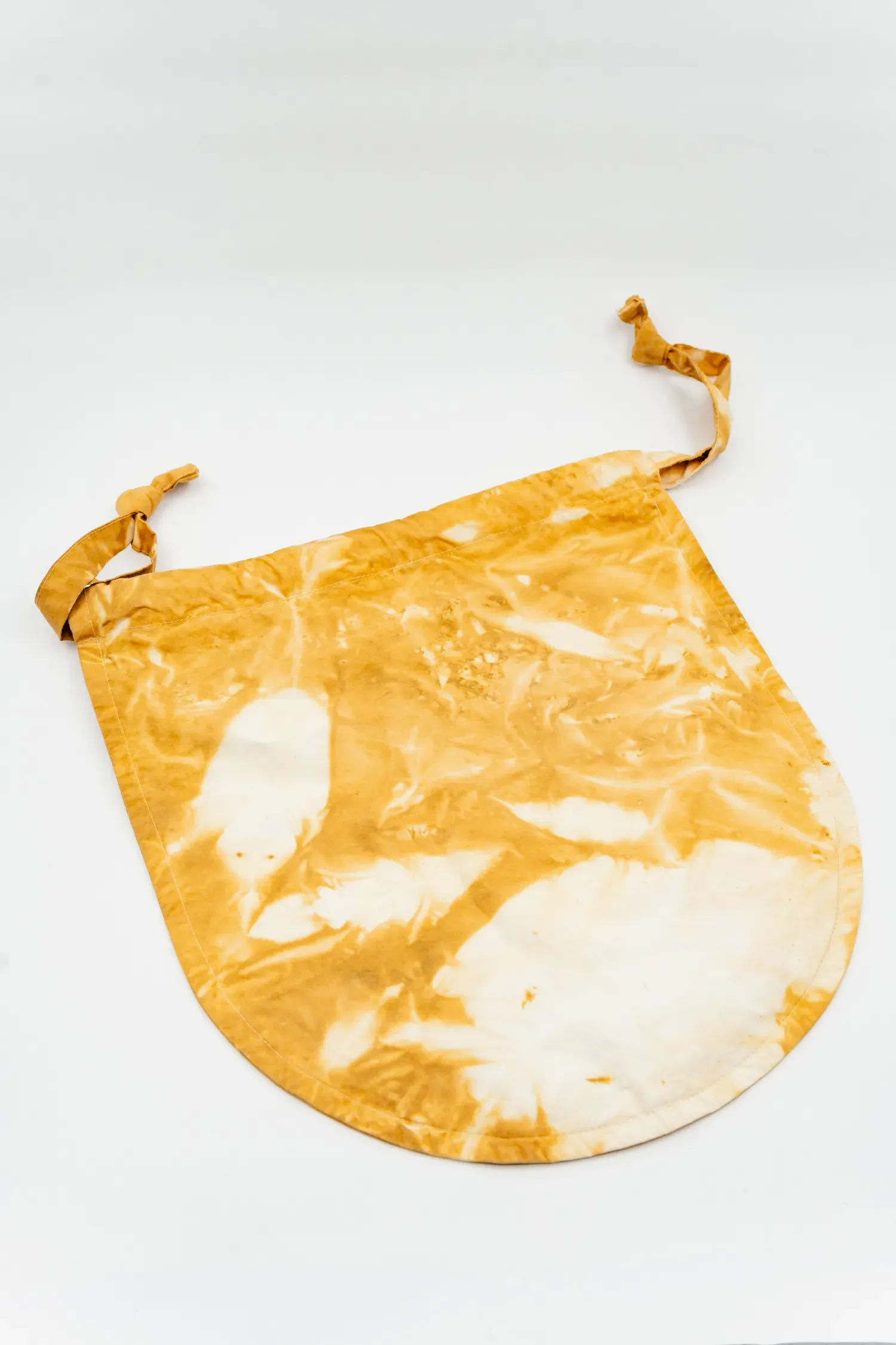 Wallpaper: "Compost Dye pouch made of hotel linen dyed with marigolds recovered from offerings at shrines across Potato Head"