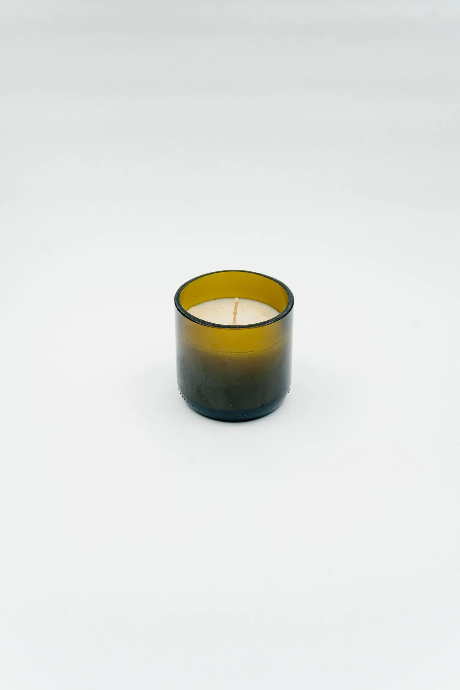 Wallpaper: "Waste cooking oil candle, in a glass container cut from a beer bottle"