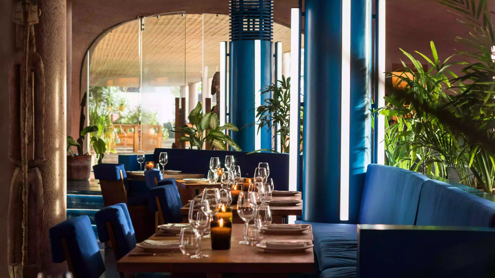 Elegant candlelit table setting at Dome restaurant, Desa Potato Head Bali — a wine bar in Seminyak offering festive dinner experiences