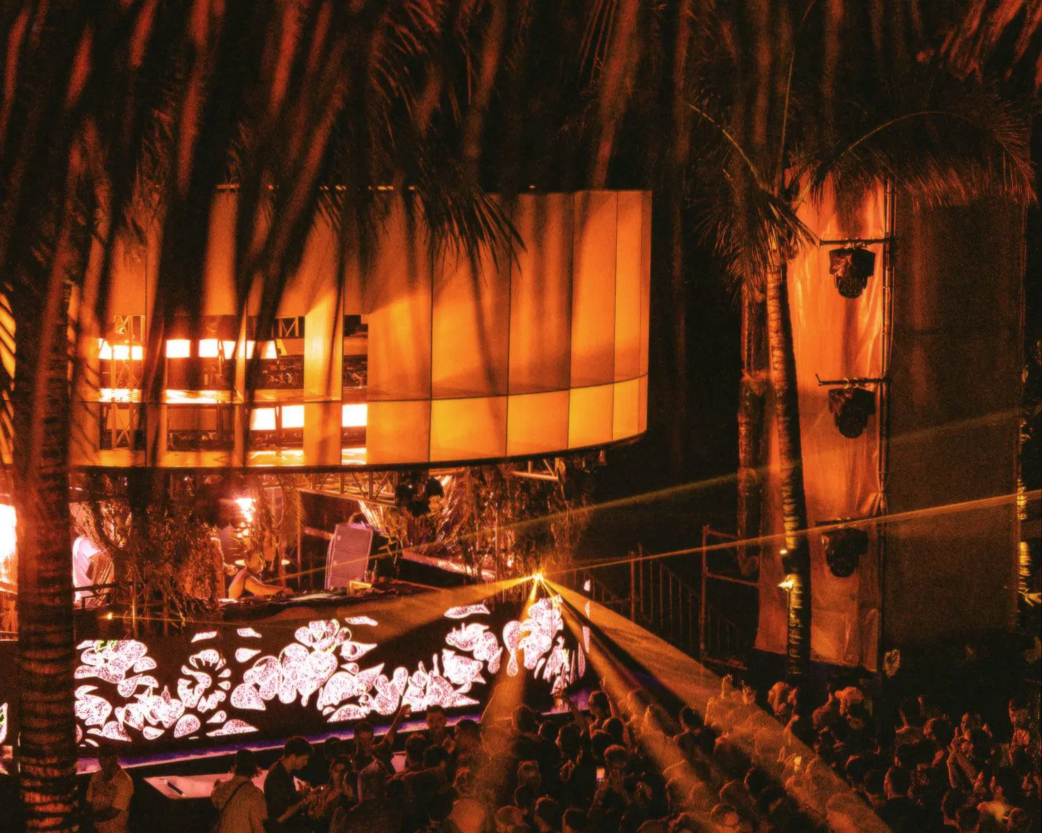 Crowd dancing under the night sky at Potato Head Bali’s NYE 2024 party.